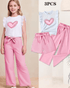 Children's outfit with white top and pink pants, featuring a heart design, on a beige background