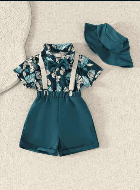 Children's outfit with leaf-patterned shirt, shorts, suspenders, and hat on a beige background