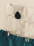 White suspenders on a textured beige background