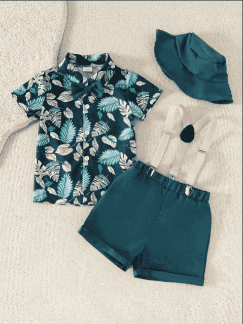 Children's outfit with a leaf-patterned shirt, shorts, and hat on a light background