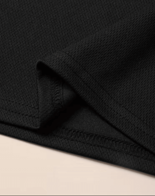 Close-up of black fabric with a beige background