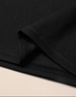 Close-up of black fabric with a beige background