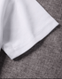 Close-up of white fabric on a textured brown surface
