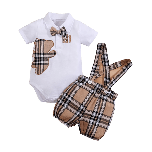 Baby outfit with white shirt, brown bear design, bow tie, and plaid shorts on a white background