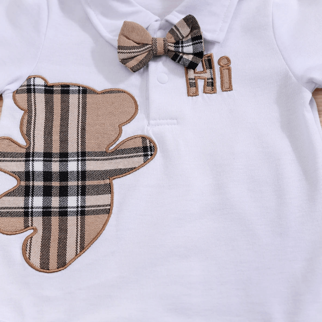 Baby outfit with plaid bear design and bow tie on a white background