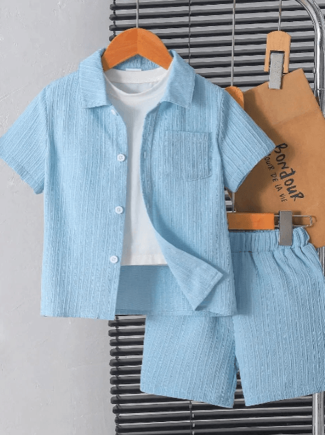 Light blue textured shirt and shorts set with a white t-shirt underneath, hanging on a rack.