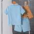 Light blue children's outfit with shirt and shorts hanging on a rack.