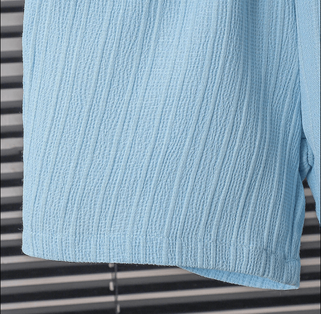 Close-up of a textured blue towel on a metal surface