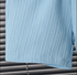 Close-up of a textured blue towel on a metal surface