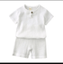 White children's outfit with a shirt and shorts on a white background