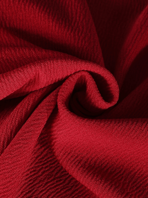 Close-up of red fabric with a textured pattern