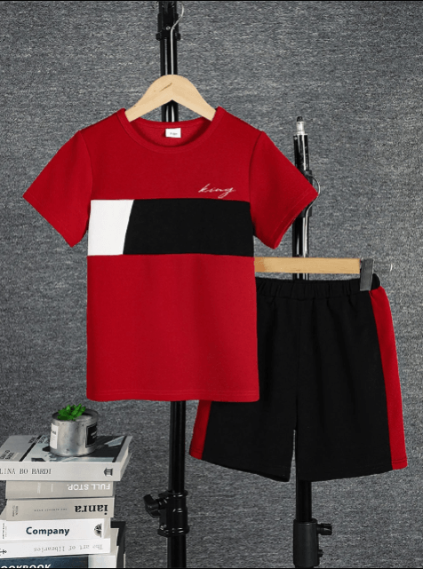 Red and black t-shirt with matching shorts on a hanger against a gray background.