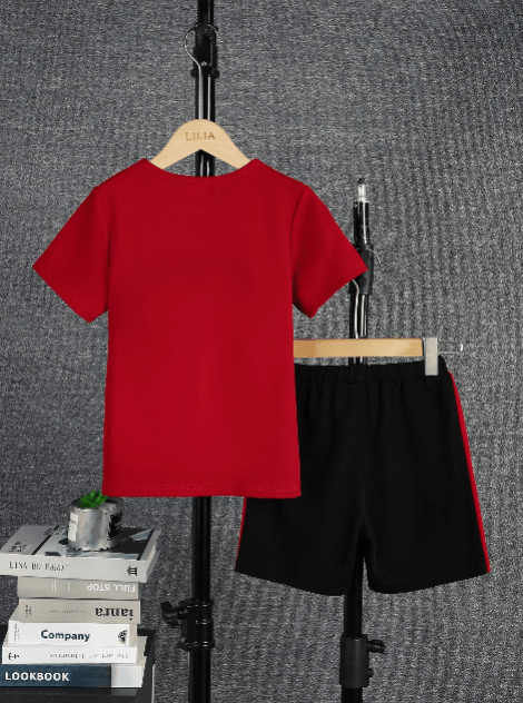 Red t-shirt and black shorts on hangers against a gray textured background