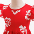 Red dress with white floral patterns on a mannequin against a white background