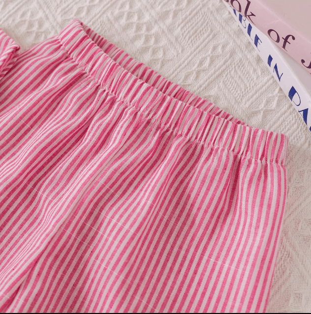 Close-up of pink and white striped pants on a textured surface