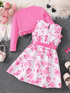 Pink sweater and floral dress on a textured surface with decorative elements.
