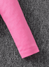 Close-up of a pink ribbed fabric sleeve on a textured gray surface