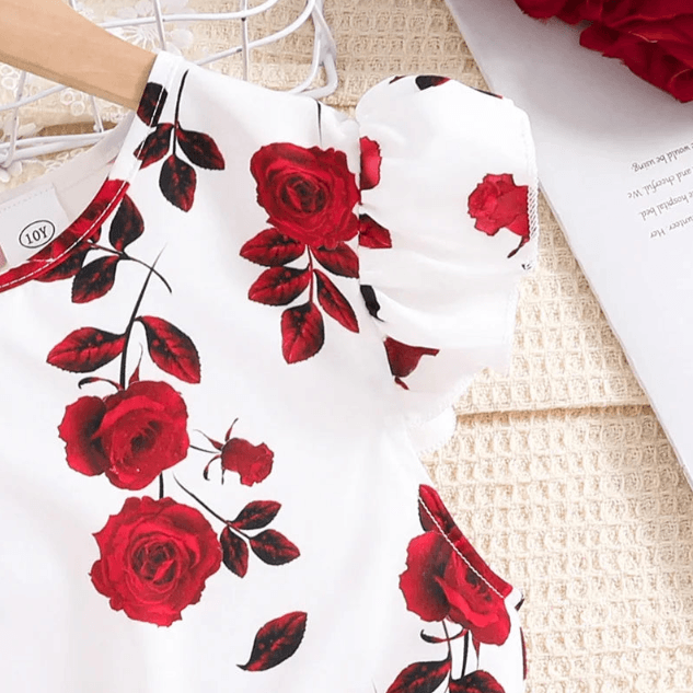 White garment with red rose pattern on a textured surface