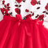 Red dress with floral lace overlay and a large bow on a white background