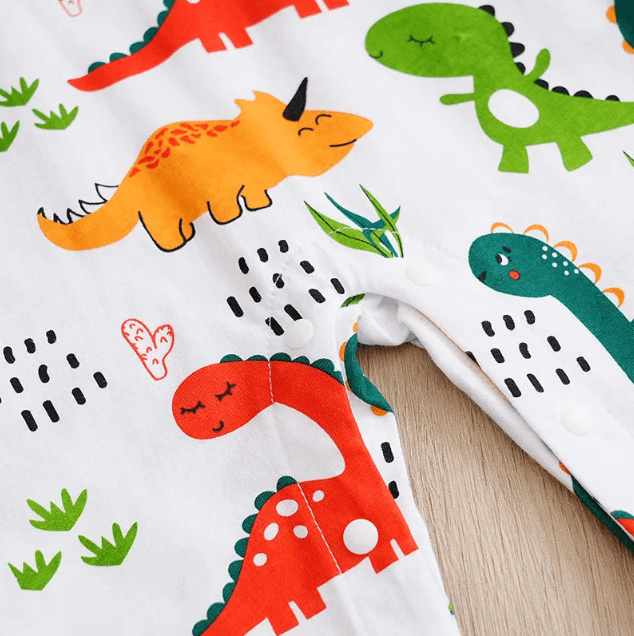 Fabric with colorful dinosaur pattern on a white background