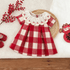Red and white checkered dress with cherry collar on a textured surface with red berries and shoes.
