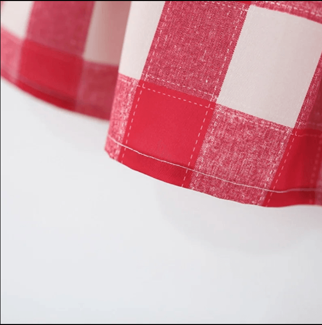 Close-up of a red and white checkered fabric edge on a white background