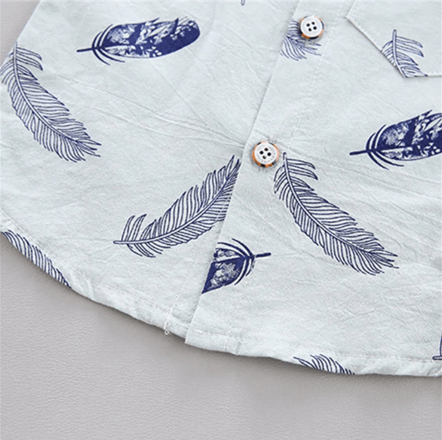 Close-up of a shirt with feather pattern on a light gray background