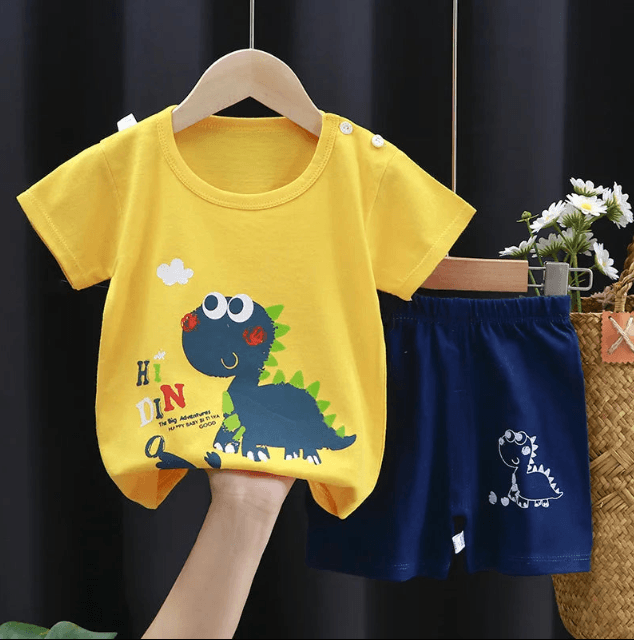 Yellow t-shirt with dinosaur design and blue shorts on a hanger against a dark background.