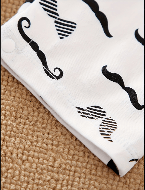 White towel with black mustache patterns on a textured surface