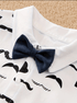 White shirt with black mustache pattern and a navy blue bow tie on a textured beige background