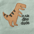 Embroidered dinosaur design with 'little dino dude' text on a light green background