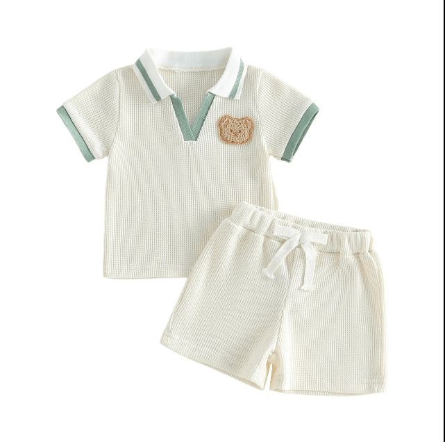 Children's outfit with striped polo shirt and shorts on a white background
