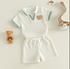 Children's outfit with shorts and shirt on a light background