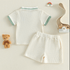 Children's outfit with white shirt and shorts on a light background