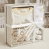 Baby gift set with clothes and toys in a transparent box, branded 'Kris x Kids'.