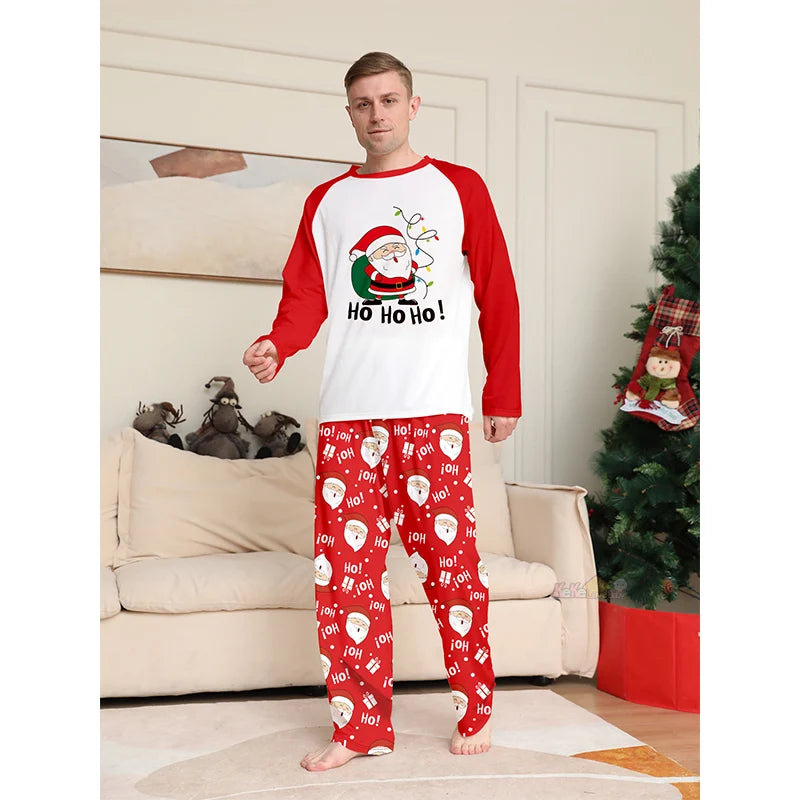Man wearing Christmas-themed pajamas with a festive design in a living room.