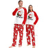Two people wearing matching Christmas pajamas with Santa Claus and 'Ho Ho Ho!' text.