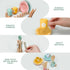Children's play kitchen set with colorful cups, plates, and utensils on a white background.