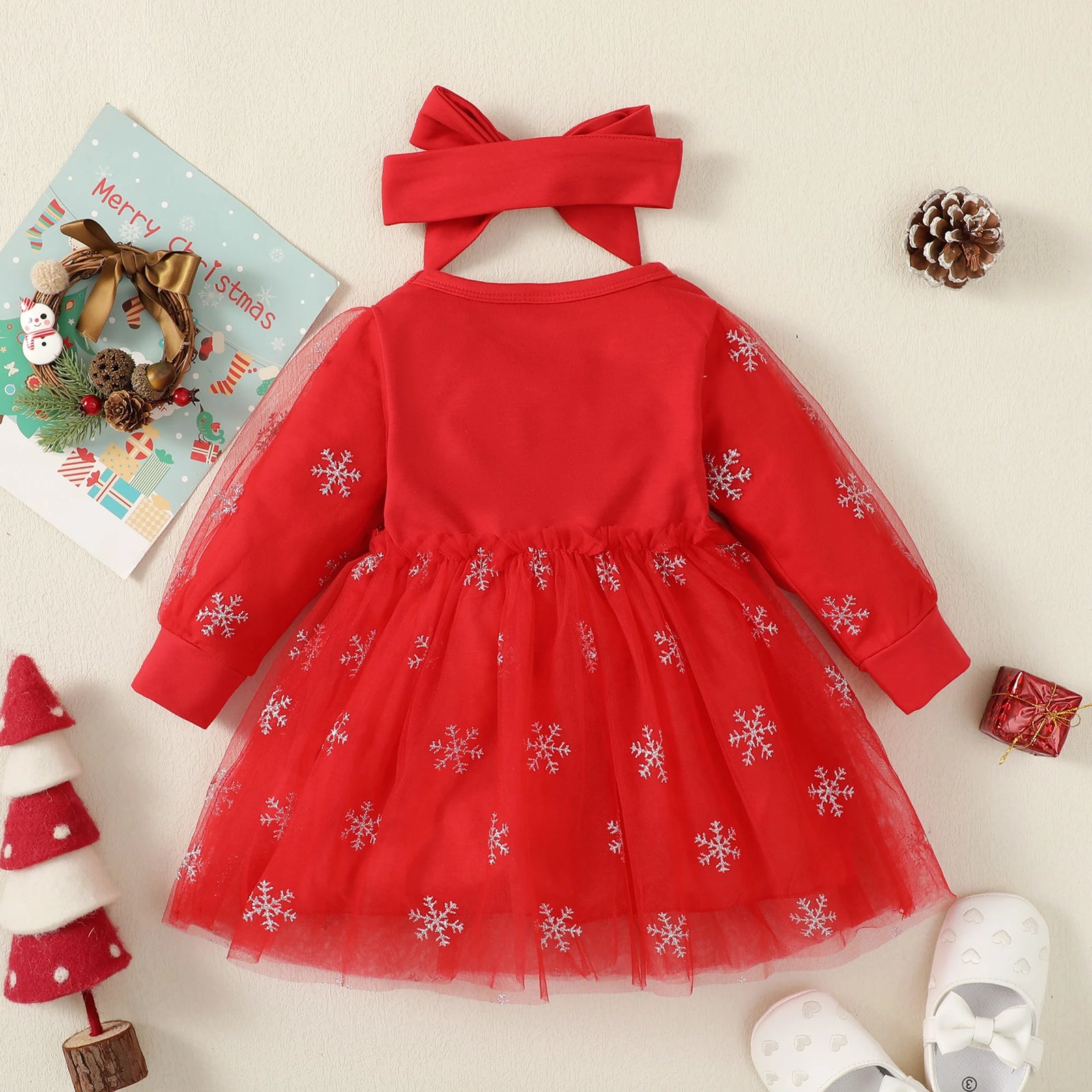 Red dress with snowflake patterns on a light background