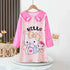 Children's dress with Hello Kitty design on a hanger against a neutral background