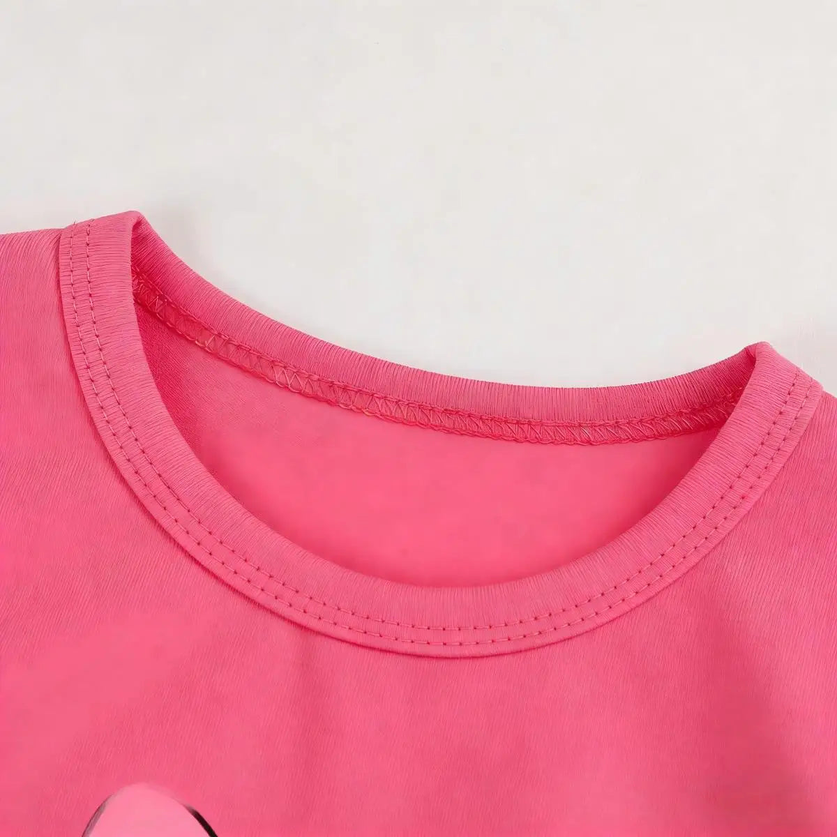 Close-up of a pink shirt collar on a light gray background