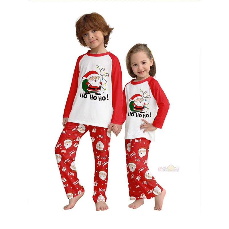 Two children wearing Christmas-themed pajamas with Santa Claus and 'Ho Ho Ho!' text on a white background.