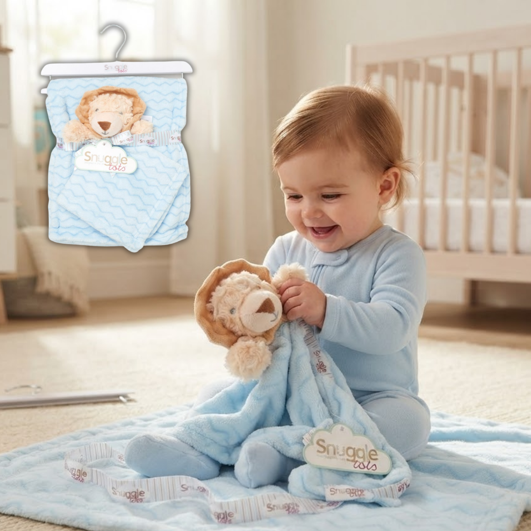 A baby in a light blue onesie sits on a blanket in a nursery, holding a plush lion toy and a light blue Snuggle Cloud blanket. An inset shows the matching Snuggle Cloud baby diaper pack hanging on a hanger.