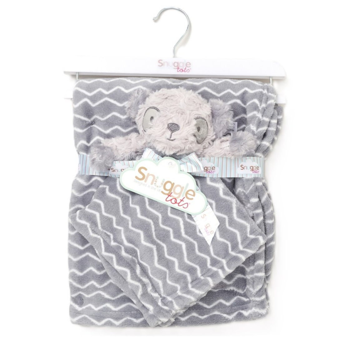 Gray chevron patterned blanket with a teddy bear plush toy on a hanger, branded 'Snuggle Tots'.