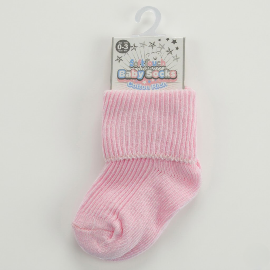 Pink baby sock on a hanger with a visible brand label against a light gray background