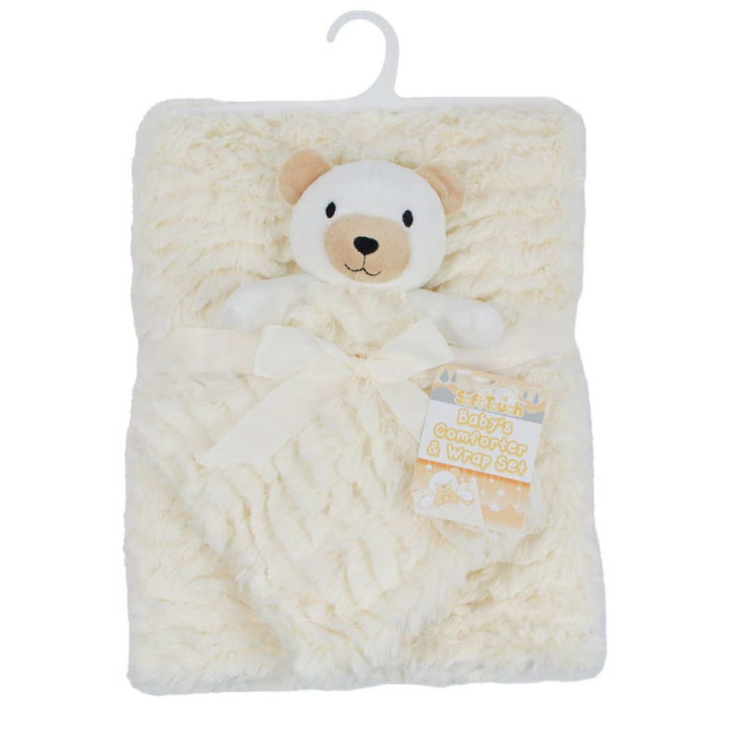 A cream-colored plush baby blanket with a teddy bear face and a matching ribbon bow, hanging on a white plastic hanger against a white background.
