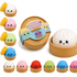 Set of colorful squishy dumplings with a wooden basket on a white background