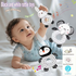 Baby playing with black and white rattle toys on a light background