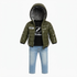 A toddler boy's outfit consisting of an olive green hooded puffer jacket with a black graphic t-shirt underneath and light blue jeans, displayed on a white background.