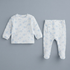 A baby two-piece outfit set featuring a long-sleeve waffle-knit top and matching footed pants, both in white with a light blue cloud pattern, displayed on a solid gray background.